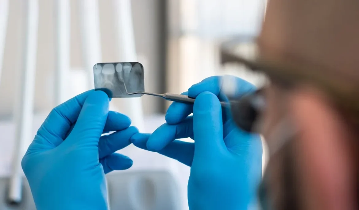 Dentist looks at X-ray of teeth
