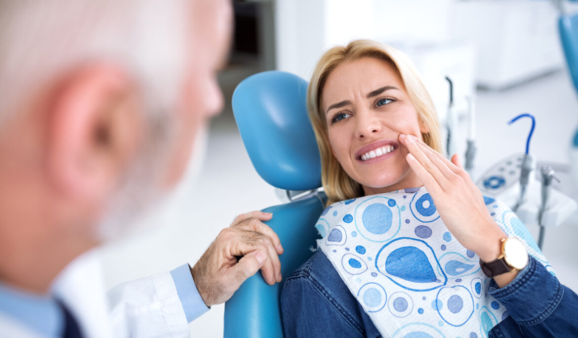 A young patient visits the dentist because she has tooth pain